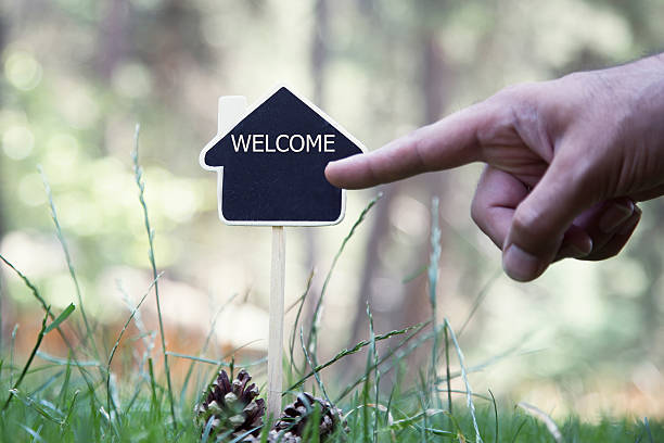 istock House Shaped Chalkboard sign on nature WELCOME HOME 594479848