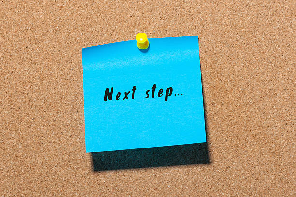 Next step words written on blue sticker pinned at notice