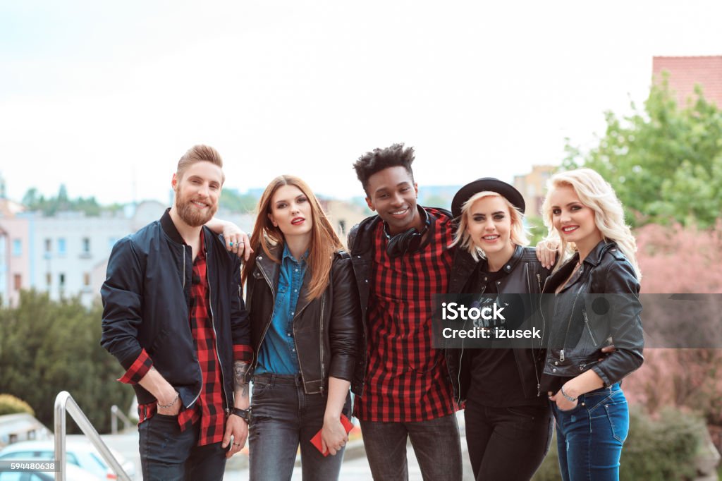 Multi ethnic group of friends, outdoor portrait Outdoor portrait of multi ethnic group of care young people, smiling at the camera. 20-29 Years Stock Photo