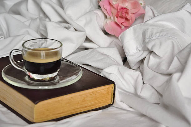 istock Cup of coffe with books and a rose 594480642