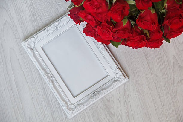 istock White frame and bunch of red roses 594482902