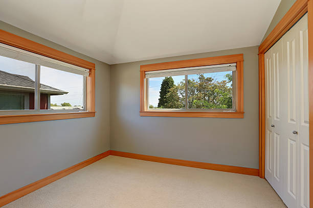 istock Grey interior of empty room with two windows. 594483332
