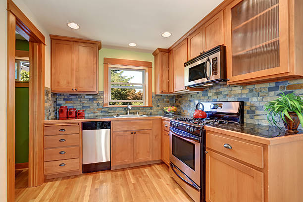 Light brown kitchen cabinetry and brick tile back splash trim stock photo