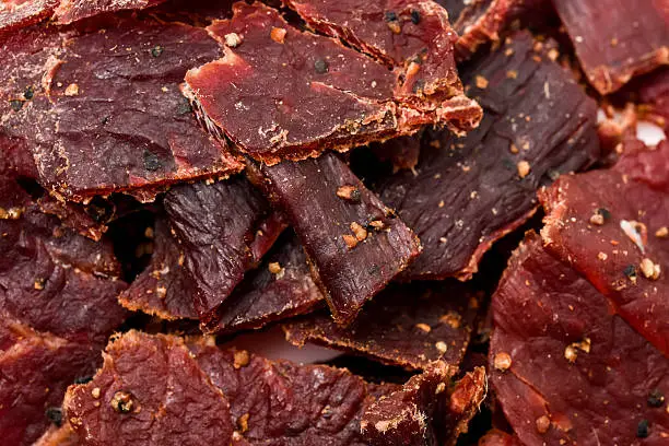Heap of peppered Beef Jerky from above full frame