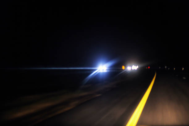 istock Intentional Blur Abstract Night Expressway Approaching Traffic Lens Flare Headlights 594487920