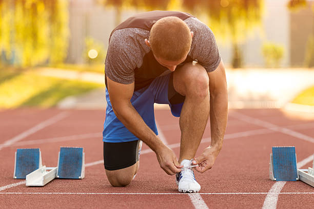 istock Female athlete tying laces for jogging. 594489640