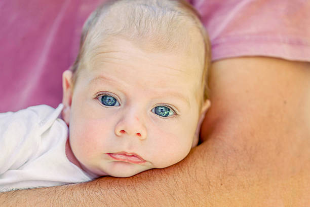istock Cute 4-Month Newborn Lying On Father Arms 594489706