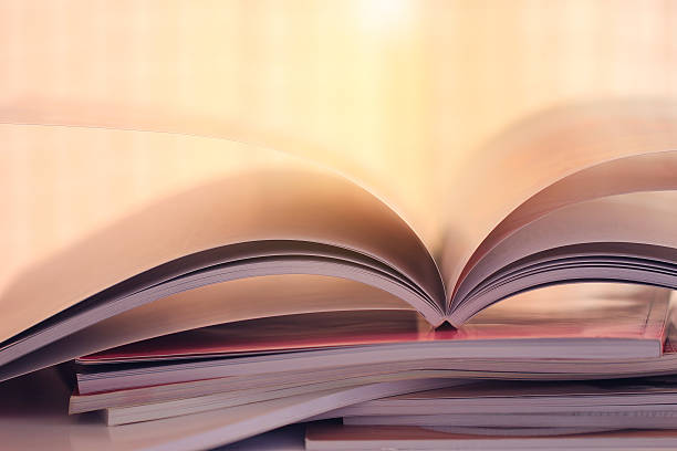 istock selective soft focus of open and Stacking of magazines 594491272
