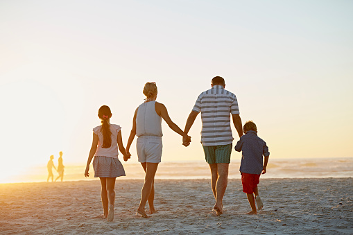 Relax, travel and happy with big family at the beach on Mexico vacation with love, support and summer. Sunset, nature and trust with grandparents, children and parents holding hands on holiday