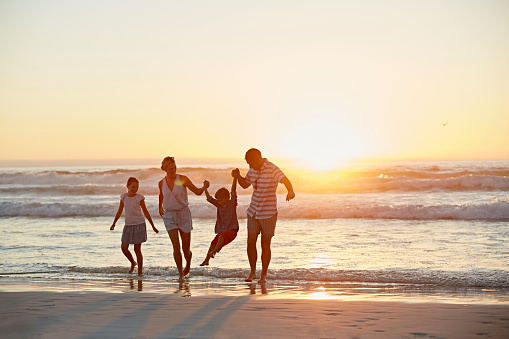 Parents with children enjoying vacation on beach photo