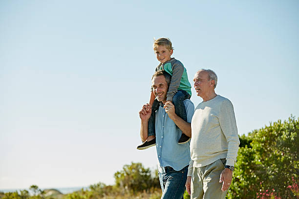 happy three generation males walking on field - 2232 photos et images de collection