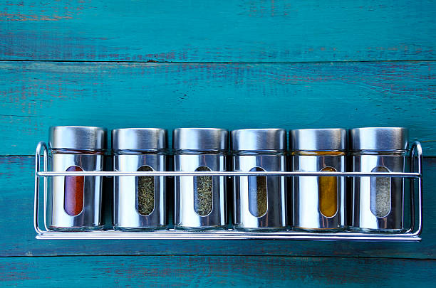 Spice rack on a wooden wall Spice rack on a wooden wall. Food background. copy space spice rack stock pictures, royalty-free photos & images