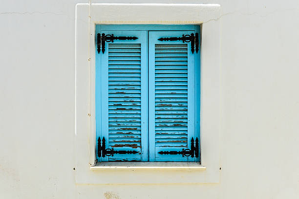 Blue balconies and windows on white buildings - Greece