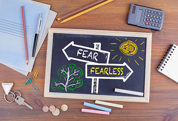 istock Fear - Fearless signpost drawn on a blackboard 594911524