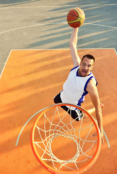 istock View of flying ball to basket from top. Face gesture. 594915086