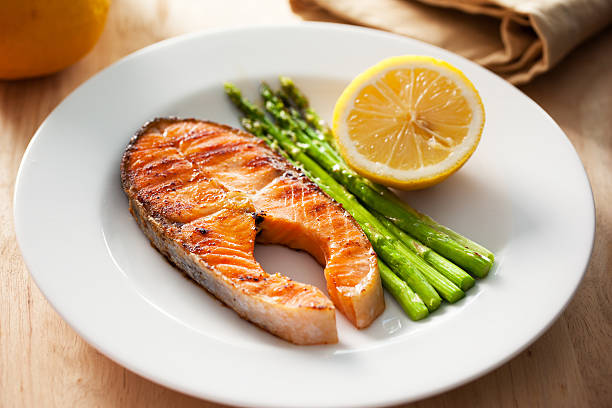 istock grilled salmon steak with asparagus and lemon 594915108