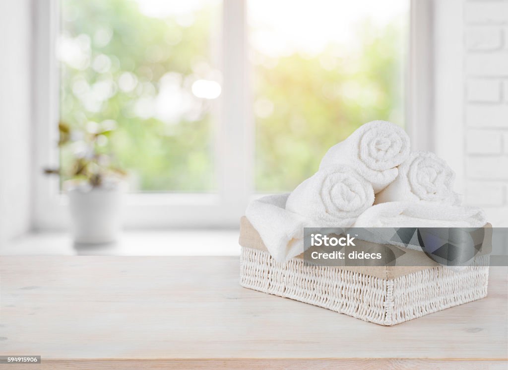 Basket with towels on window sill over summer day background - Royaltyfri Handduk Bildbanksbilder