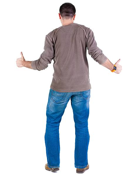 istock Young man thumbs up. rear view. 594916218