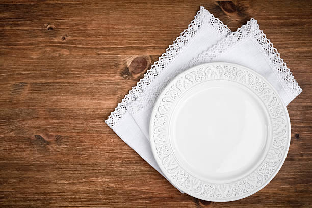 istock Vintage ceramic plate over table napkin on dark wooden background 594917944