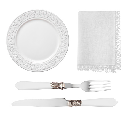 Vintage plate, knife, fork and napkin isolated on white background