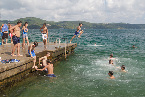 Istanbul, Turkey - August 19, 2016 : Turkish children are swim to cool off the coast of Sariyer.