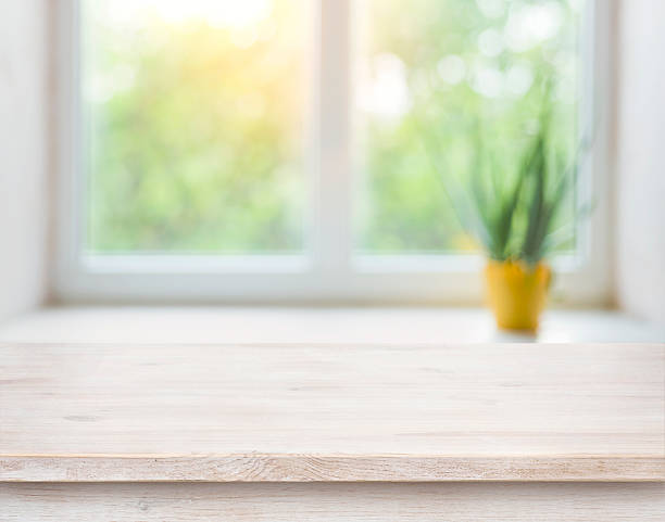 istock Wooden table on blurred autumn window with plant pot background 594918622