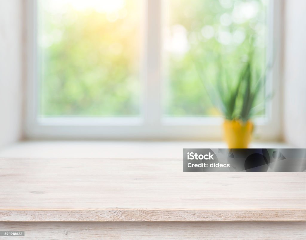 Wooden table on blurred autumn window with plant pot background Kitchen Stock Photo