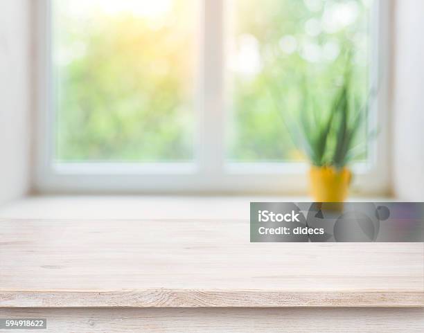 Wooden Table On Blurred Autumn Window With Plant Pot Background Stock Photo - Download Image Now
