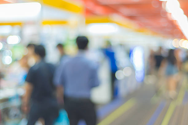 istock Abstract of blurred people walking in shopping centre 594919606