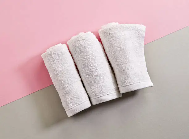 white spa towels on colorful paper background