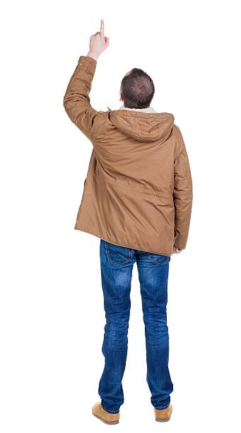 istock Back view of  pointing young men in parka. 594920224