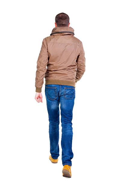 istock Back view of going  handsome man in jeans and jacket. 594920558