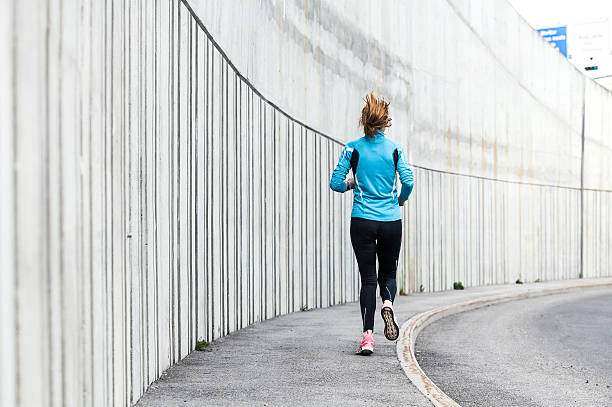 istock Female Athlete Running on the Pavement 594922170
