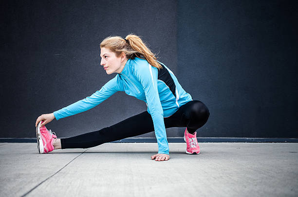 istock Female Athlete Stretching Outdoors 594922182