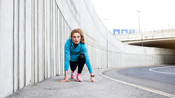 istock Female Runner Stretching on the Pavement 594922192