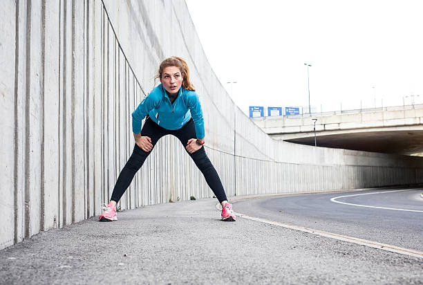 istock Female Athlete Stretching on the Pavement 594922198