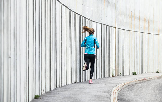 istock Female Athlete Running on the Pavement 594922208