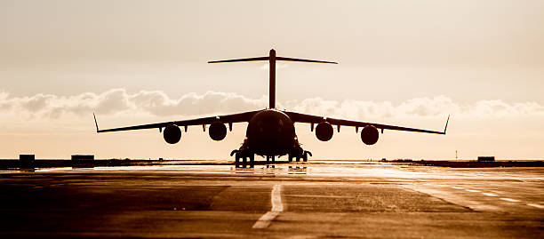 istock Large military cargo plane silhouette 594923394