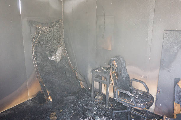 chair and furniture in room after burned by fire stock photo