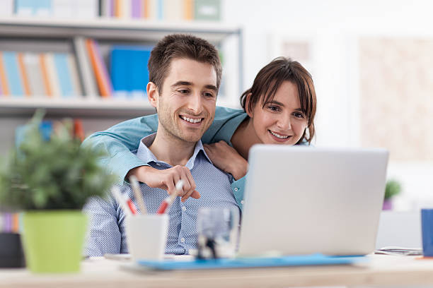 istock Happy couple at home using a laptop 594923894