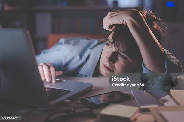 Sleepy Woman Working With Her Laptop Stock Photo - Download Image Now - Adult, Business Finance and Industry, Cluttered