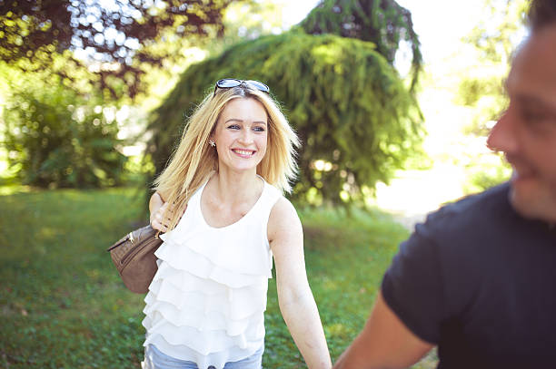 istock Young Couple Holding Hands in the Park 594924090