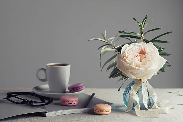 Vintage rose, coffee and macarons. Beautiful and cozy breakfast.