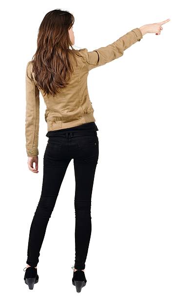 istock Back view of young brunette woman pointing 594925290