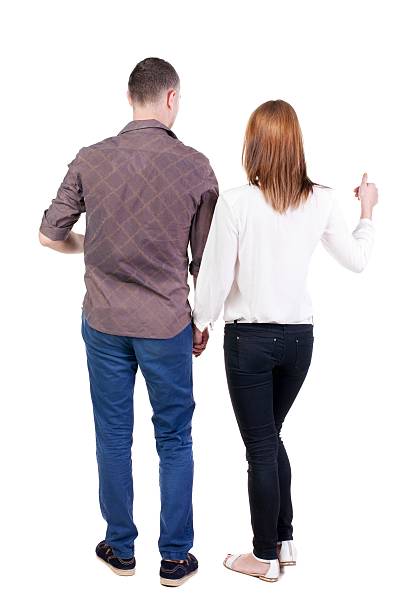 istock young couple pointing at wal Back view 594927130