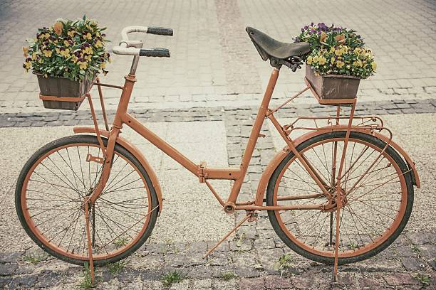 istock bicycle with flowers in retro style 594929120