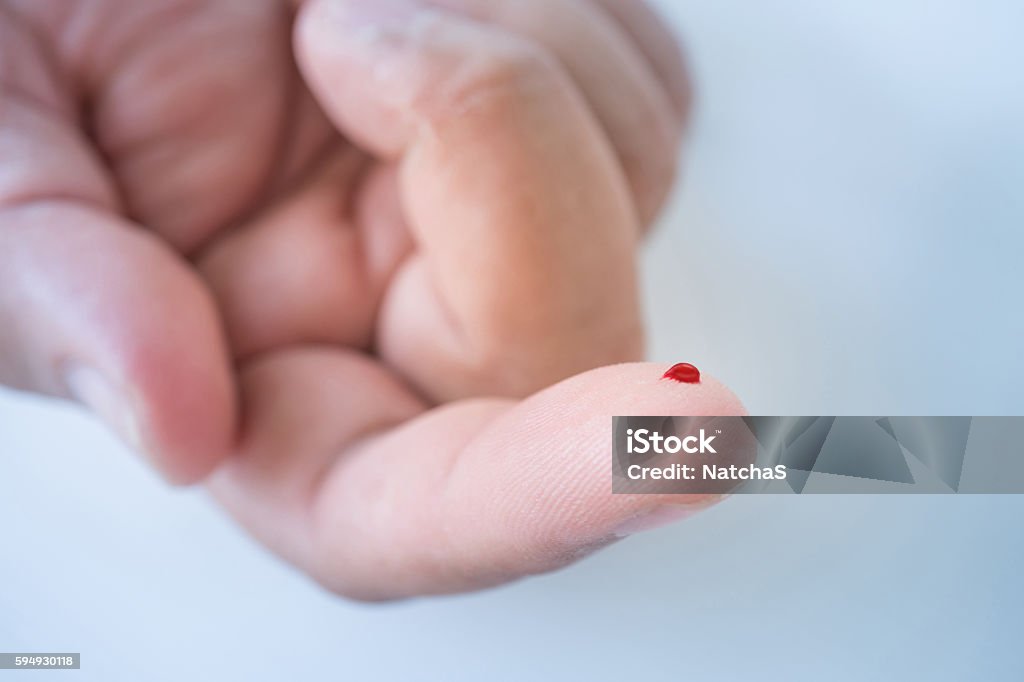 male finger with blood drop for blood testing Close up of  male finger with blood drop for blood testing Blood Stock Photo