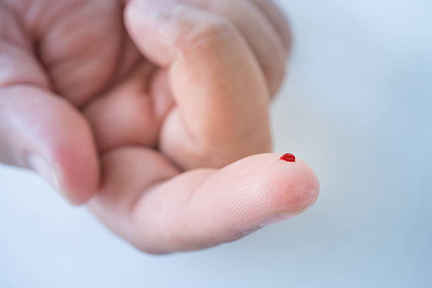 male finger with blood drop for blood testing Close up of male finger with blood drop for blood testing human finger stock pictures, royalty-free photos & images