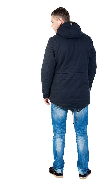 istock Back view of handsome man in winter jacket  looking up. 594930448