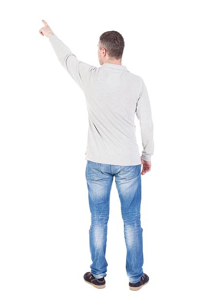 vista posterior de señalando el joven hombre en camisa y pantalones. - looking at view watching pointing showing fotografías e imágenes de stock